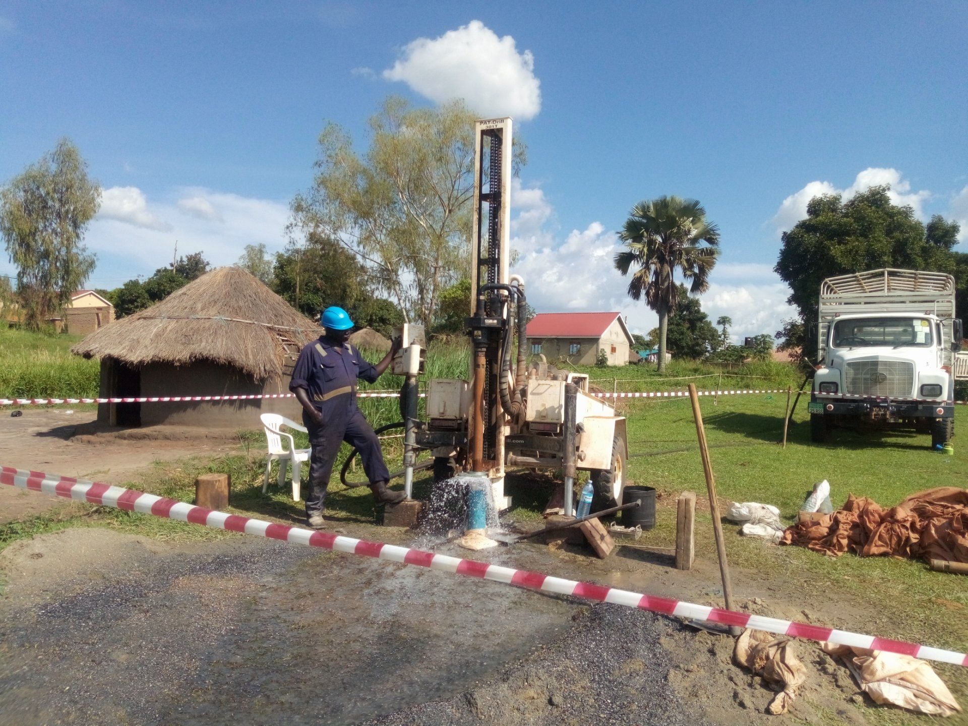 A man in a blue hard hat is working on a machine