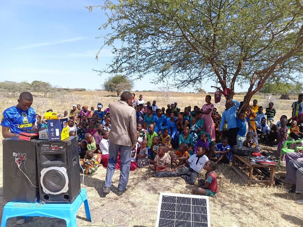 Pastor Abogasti preaching to the founding congregation of Mwakalundi Baptist Church under a tree in Tanzania