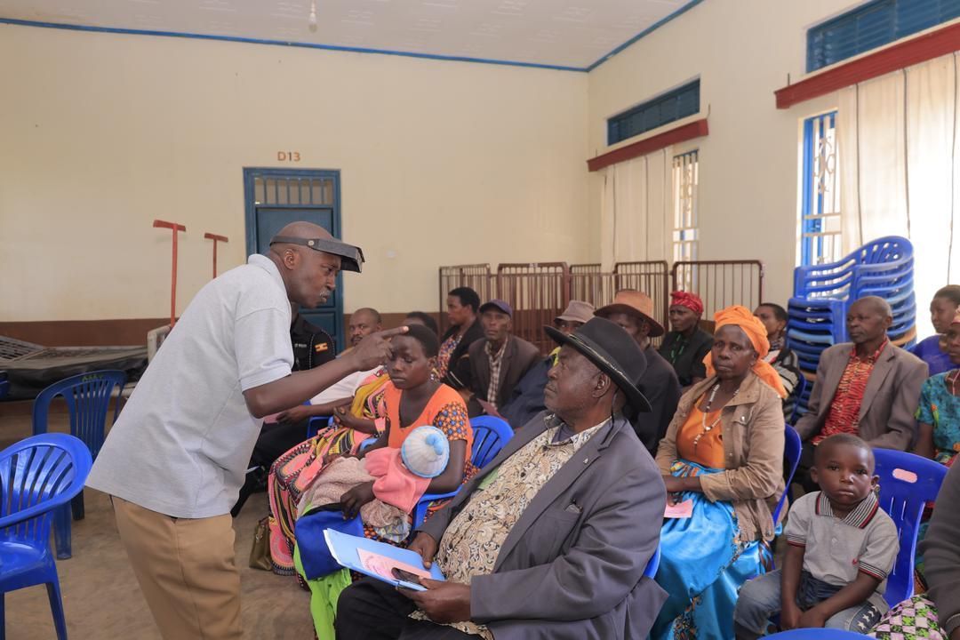 A man is talking to a group of people in a room.