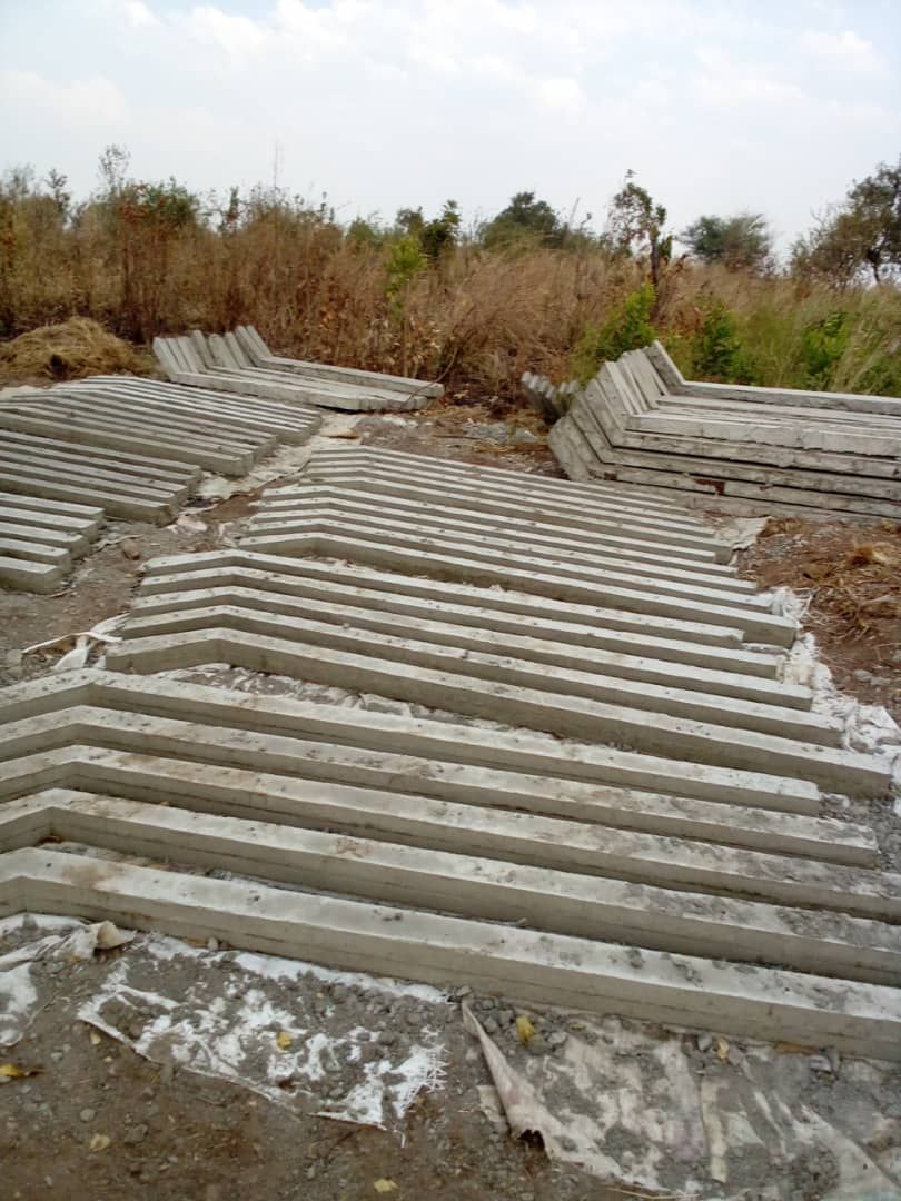 A pile of concrete blocks sitting on top of a dirt field.