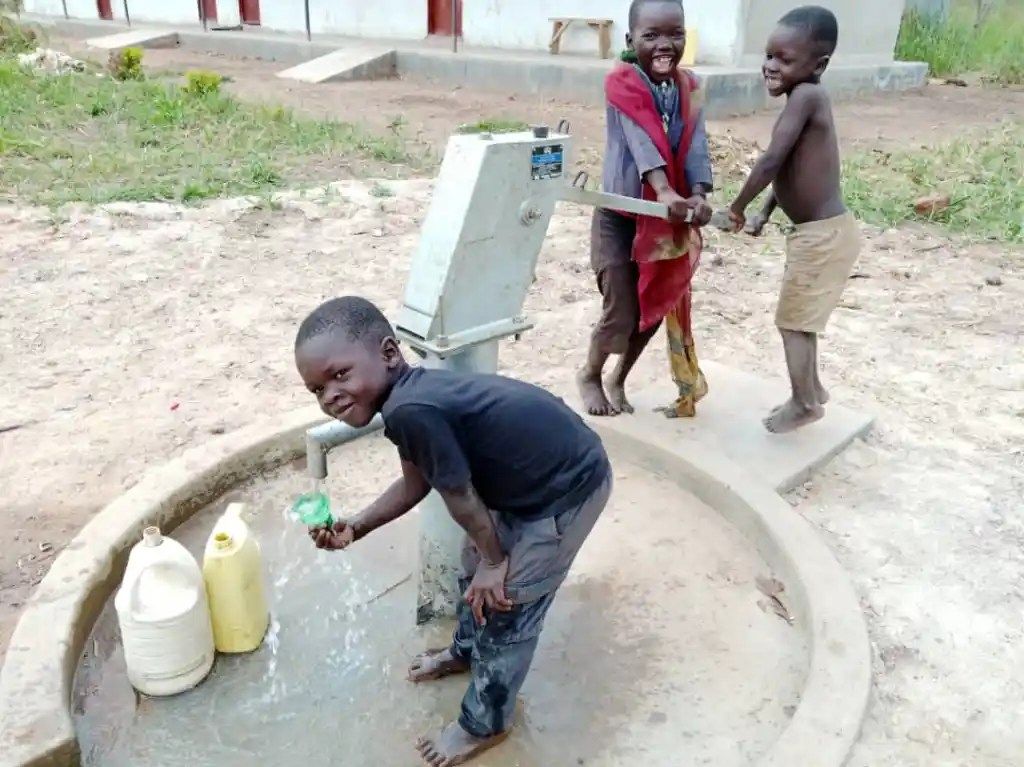 Water Well, water for life and children pumping water at Agape Baptist Church