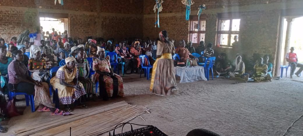 A large group of people are sitting in chairs in a room.