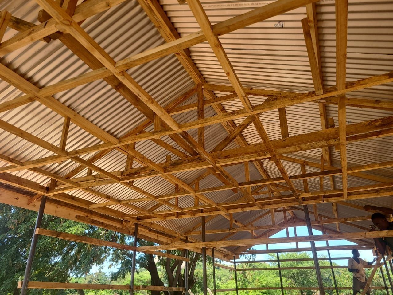 A wooden structure with a roof that is being built