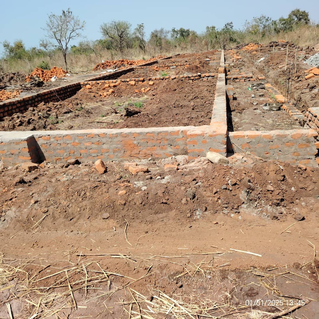A pile of concrete blocks sitting on top of a dirt field.