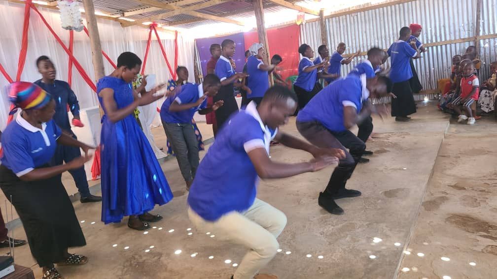 A group of people are dancing together in a room.