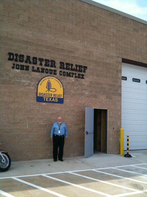 Dr. John LaNoue standing in front of the Disaster Relief John LaNoue Complex in east Dallas