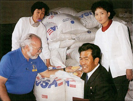 Dr. John LaNoue distributing corn to North Korea
