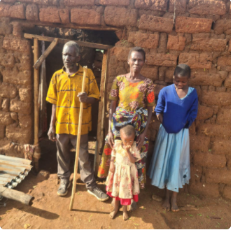 A group of people standing in front of a brick building