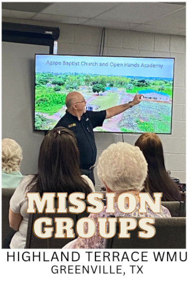 A group of people are sitting in front of a screen that says mission groups