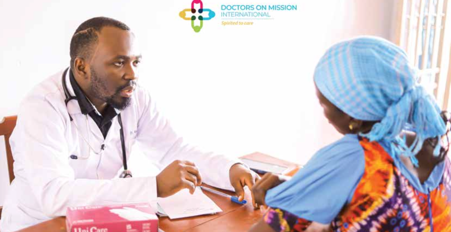 Doctor consulting with patient; white coat, stethoscope. Patient wearing blue head covering.