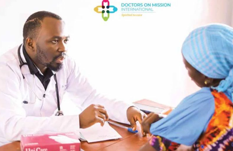 Doctor consulting with patient; white coat, stethoscope. Patient wearing blue head covering.