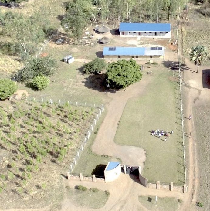 An aerial view of a farm with a blue roof