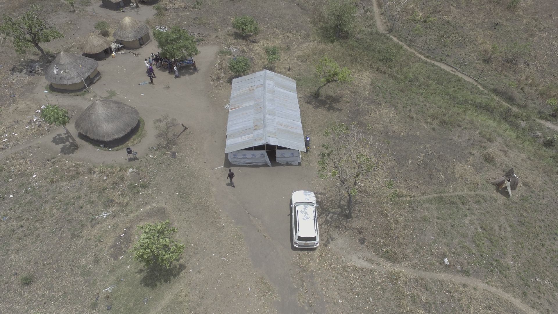 An aerial view of a tent in the middle of a field.
