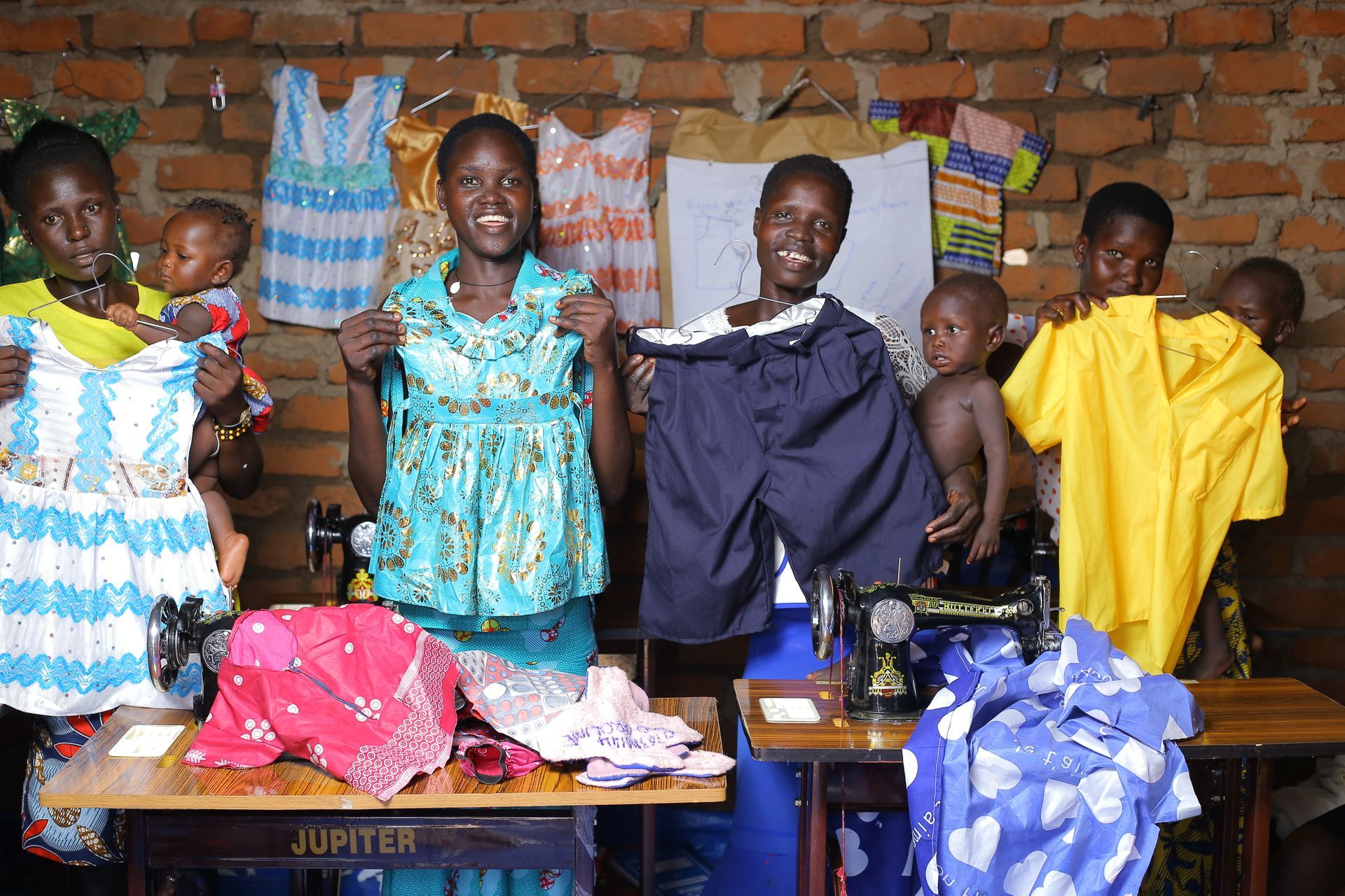A group of people standing around a jupiter sewing machine