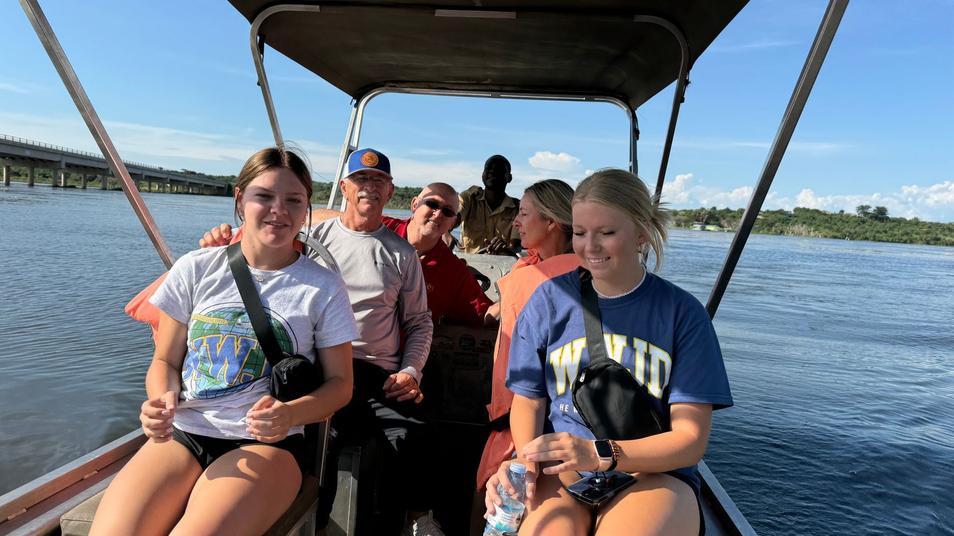 A group of people are sitting on a boat in the water.