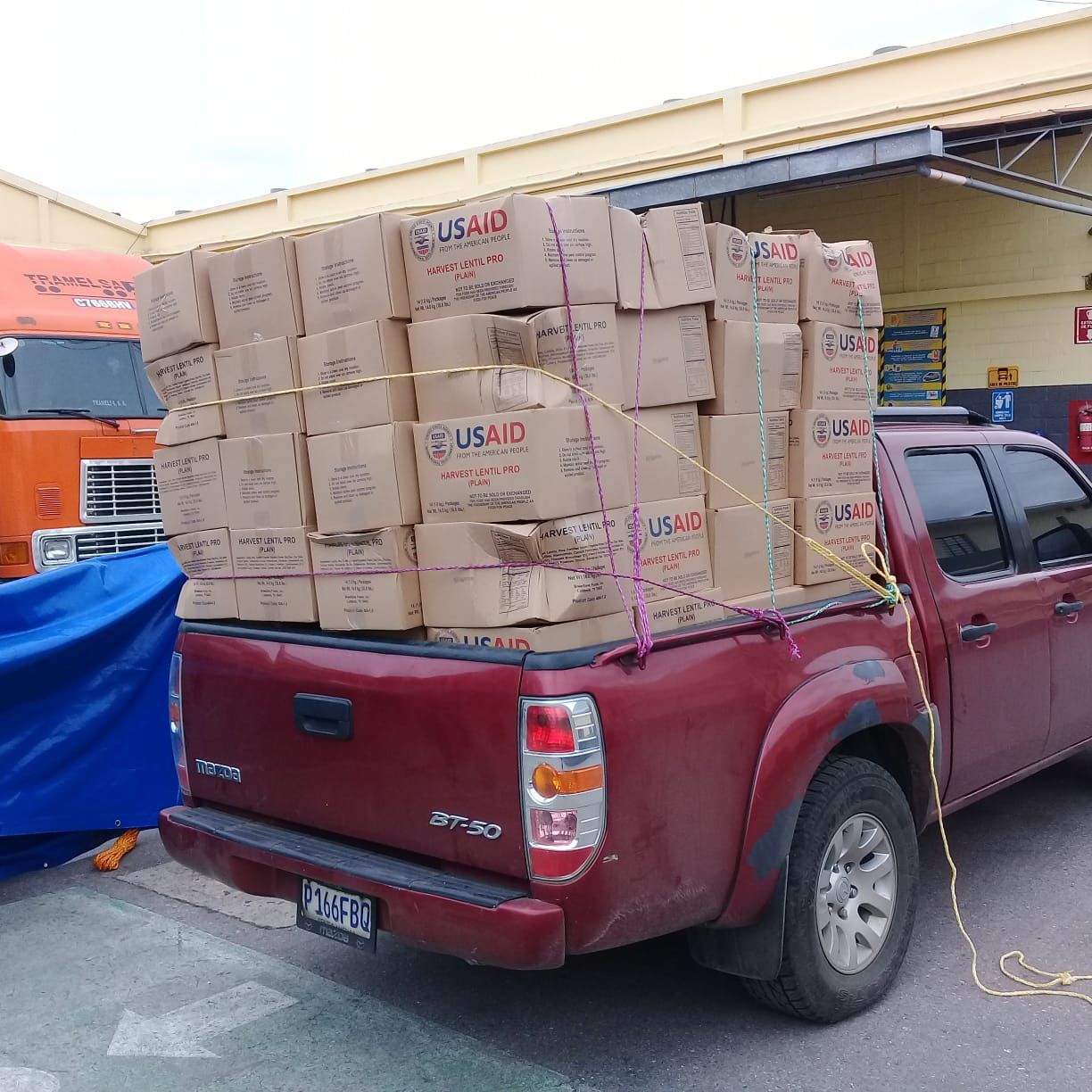 Pickup truck loaded with USAID food boxes for Guatemala volcano distribution