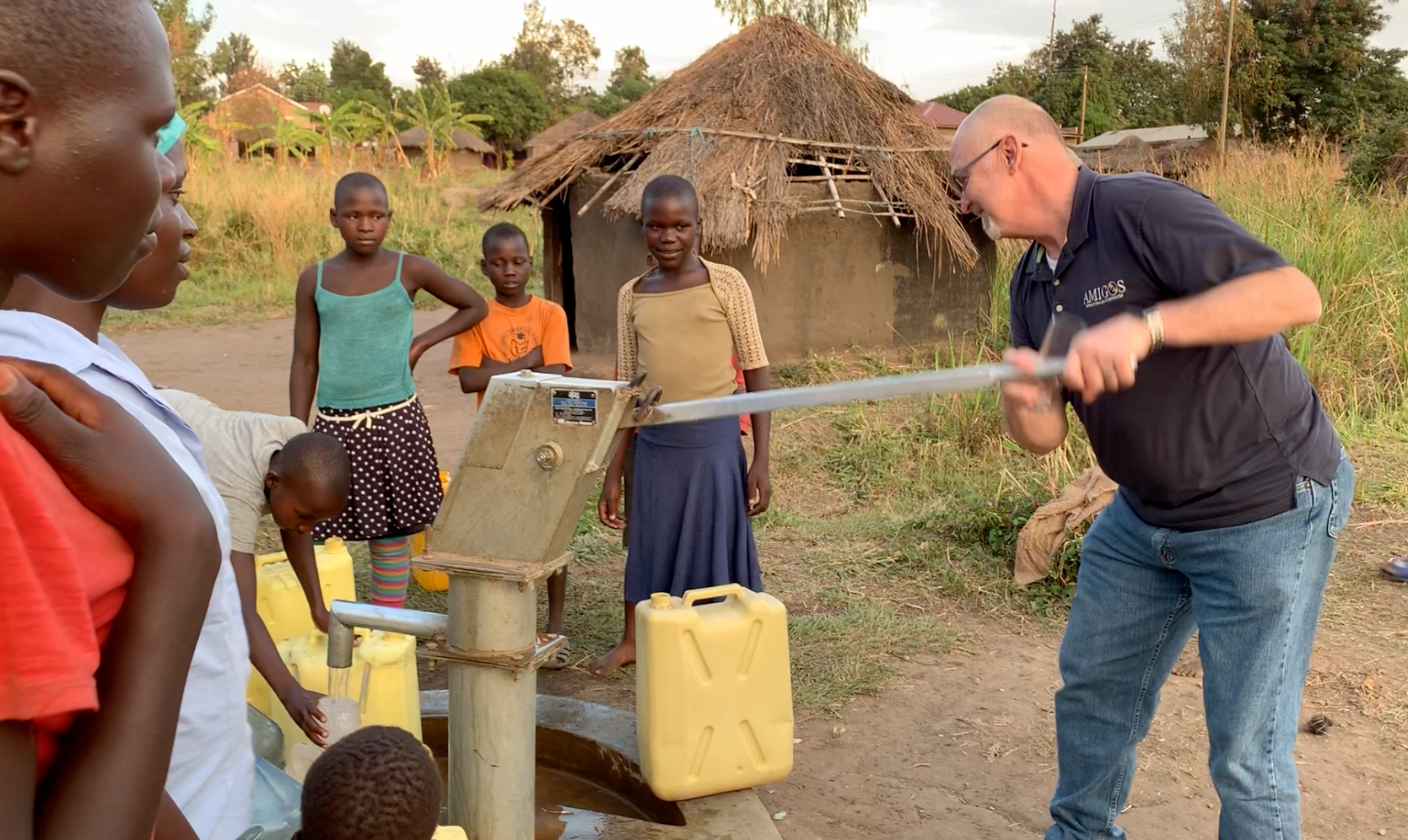 Michael Ryer pumping fresh clean water from a well Amigos just drilled