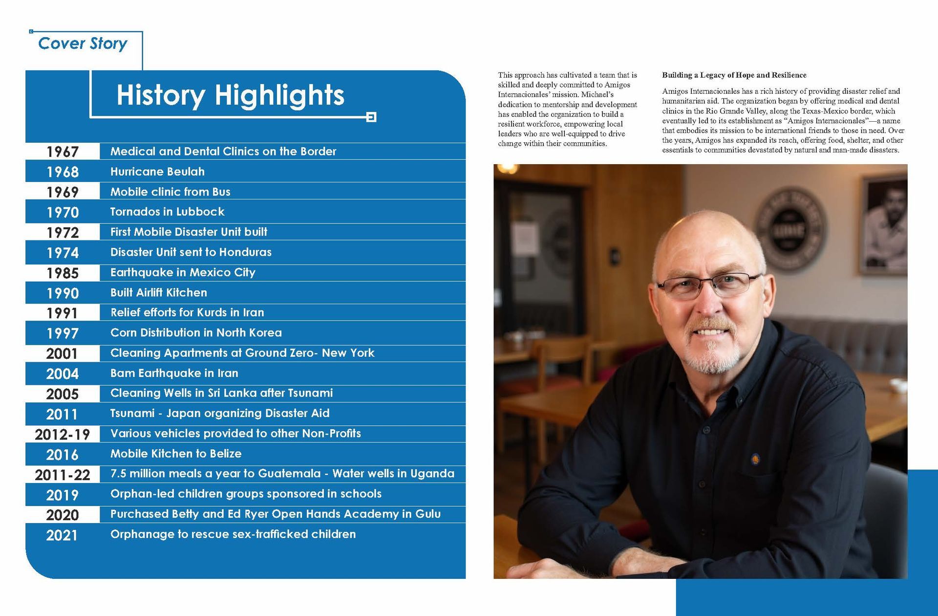 A man with glasses is sitting at a table in a restaurant.