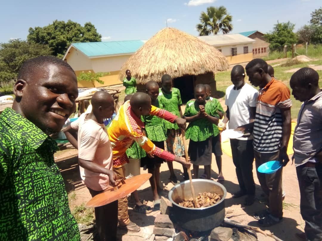 Isaac and his youth group cooking for a conference in Northern Ugandan church