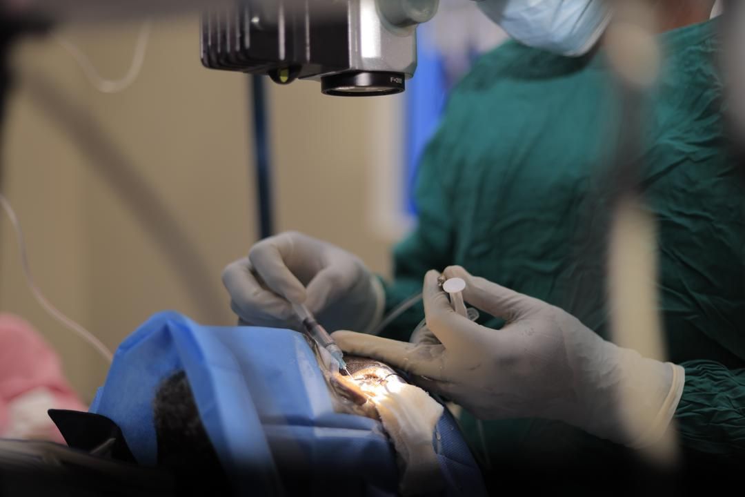 A surgeon is operating on a patient in an operating room