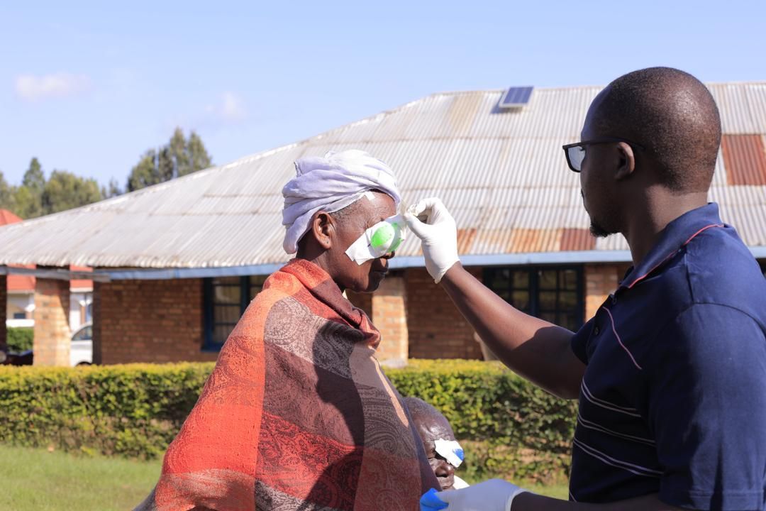 A man is taking a woman 's temperature with a thermometer.