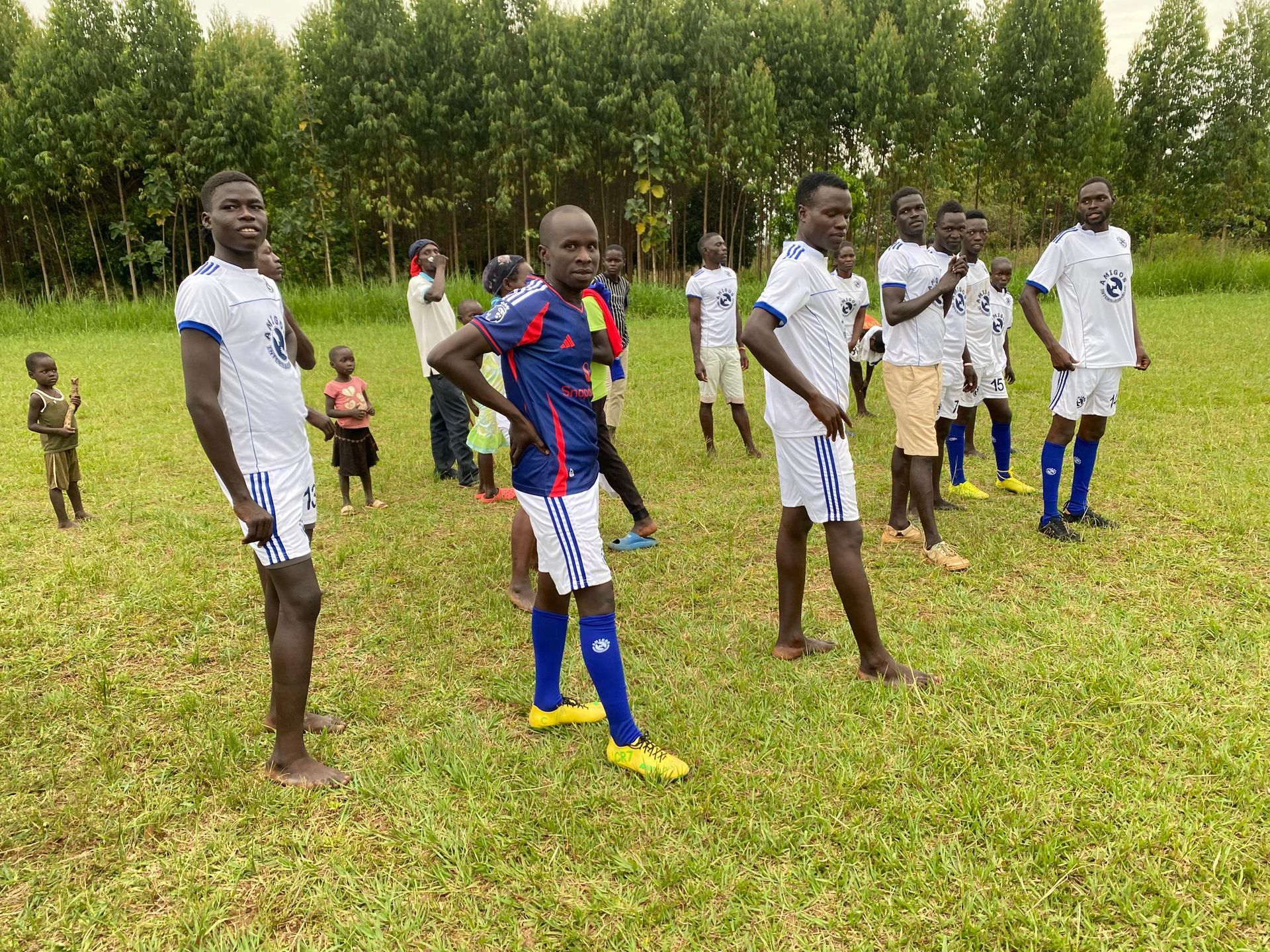 A group of soccer players are standing on a field.