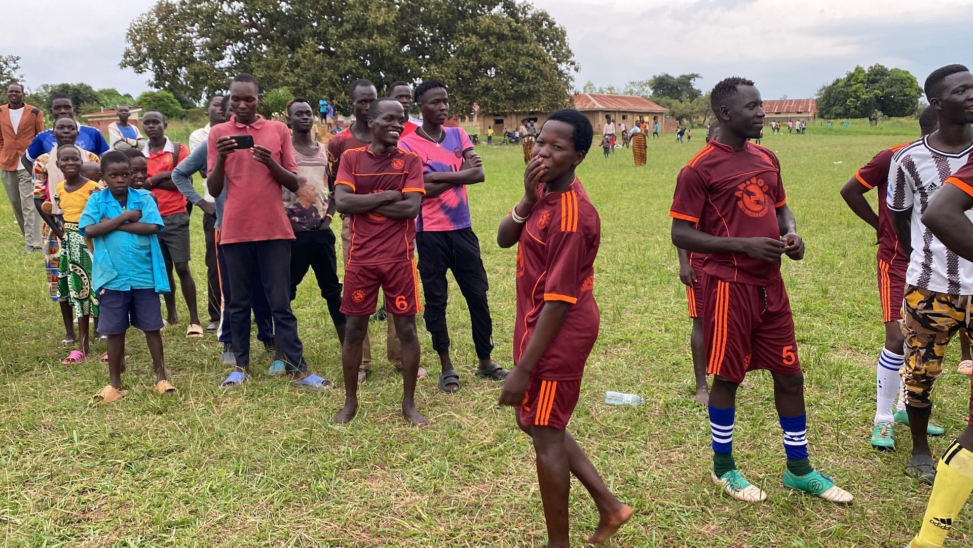 A group of young men are standing on a soccer field.