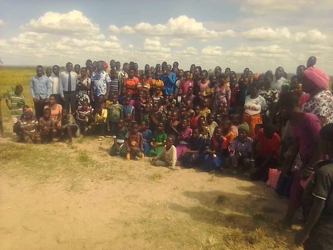 The eighty founding members of Mwakalundi Baptist Church standing together after their baptisms in Tanzania