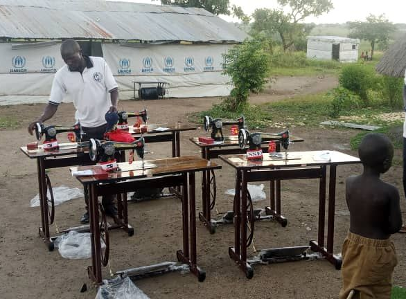 Teacher guiding students in a hands-on skills workshop