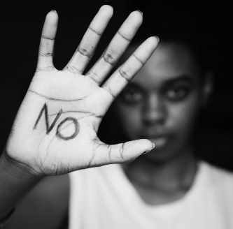 a person is holding up their hand with the word no written on it