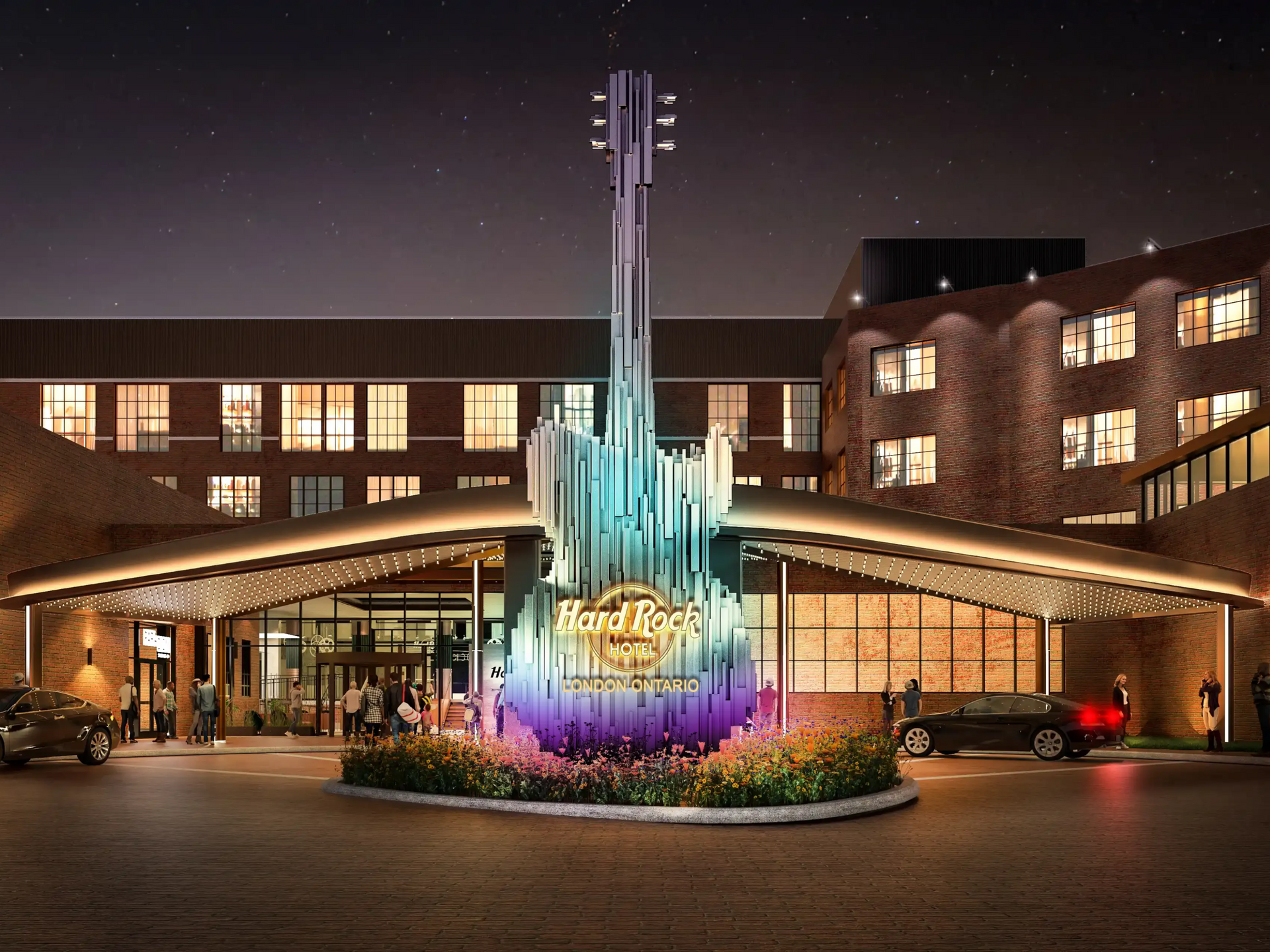 Hard Rock Hotel entrance at night, with a giant illuminated guitar sculpture in London Ontario