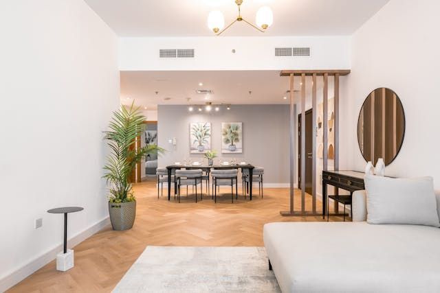 interior-of-a-living-room-featuring-a-couch-dining-table-and-wooden-floor.