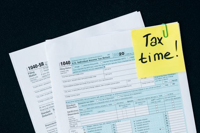 tax+papers+with+a+sticky+note+reading+Tax+time.