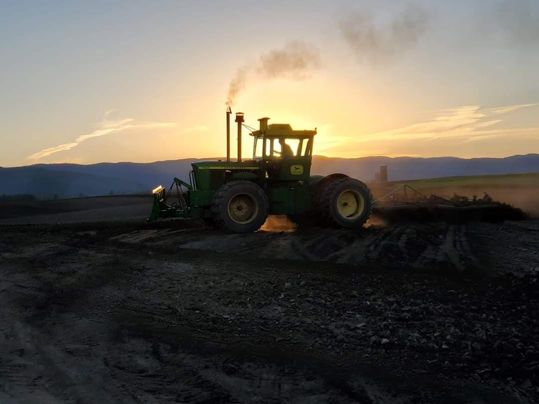 Tractor doing some work on a distance — Kalispell, MT — Pedersen & Co Pumping, Inc.