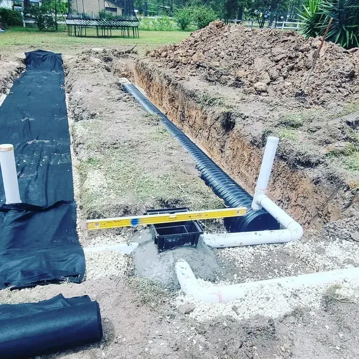 A Garden Filled with Lots of Plants and Trees with Tank — Rosewood Environmental Services Pty Ltd in Wauchope, NSW