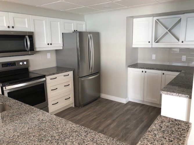 A kitchen with stainless steel appliances and granite counter tops