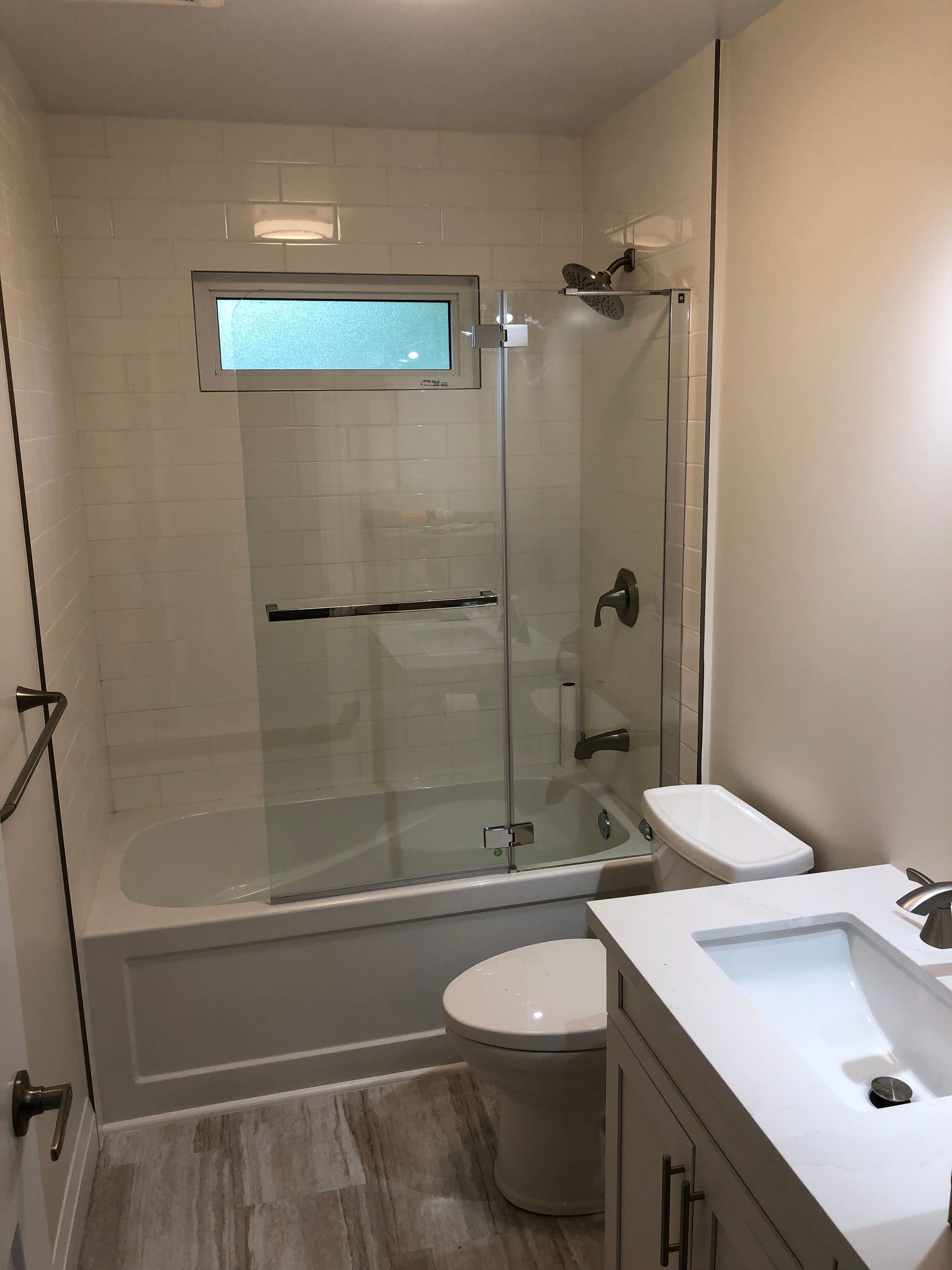 A bathroom with a tub, toilet, sink and shower.