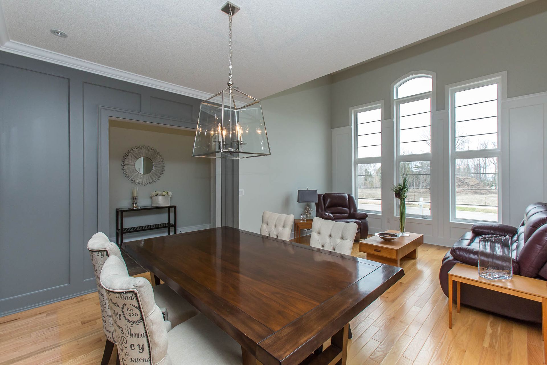 A dining room with a long wooden table and chairs.
