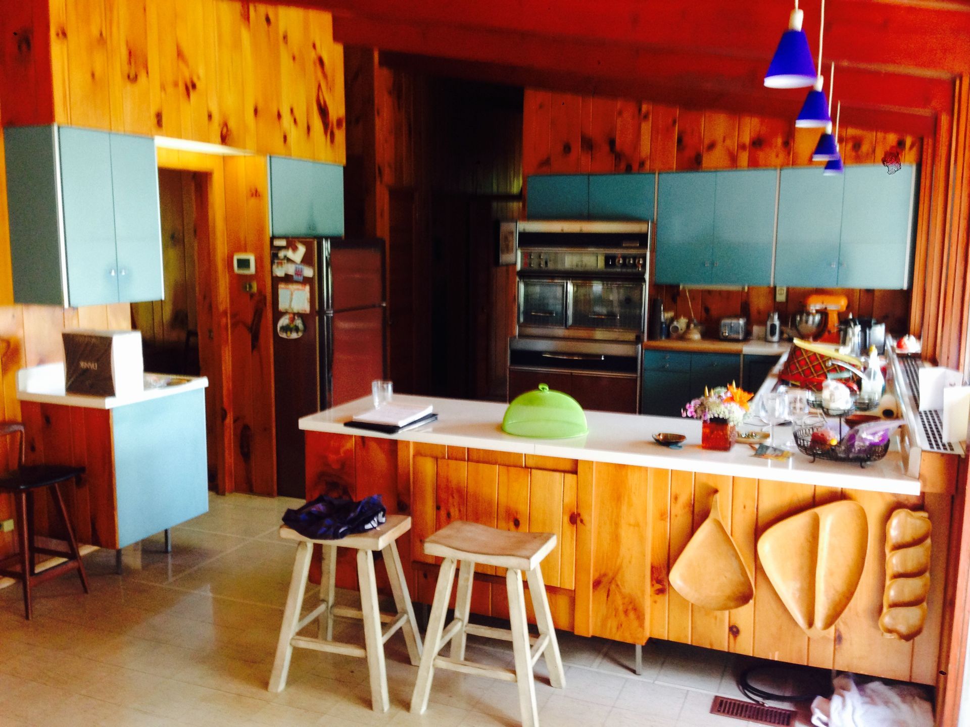 A kitchen with wooden cabinets and a large island