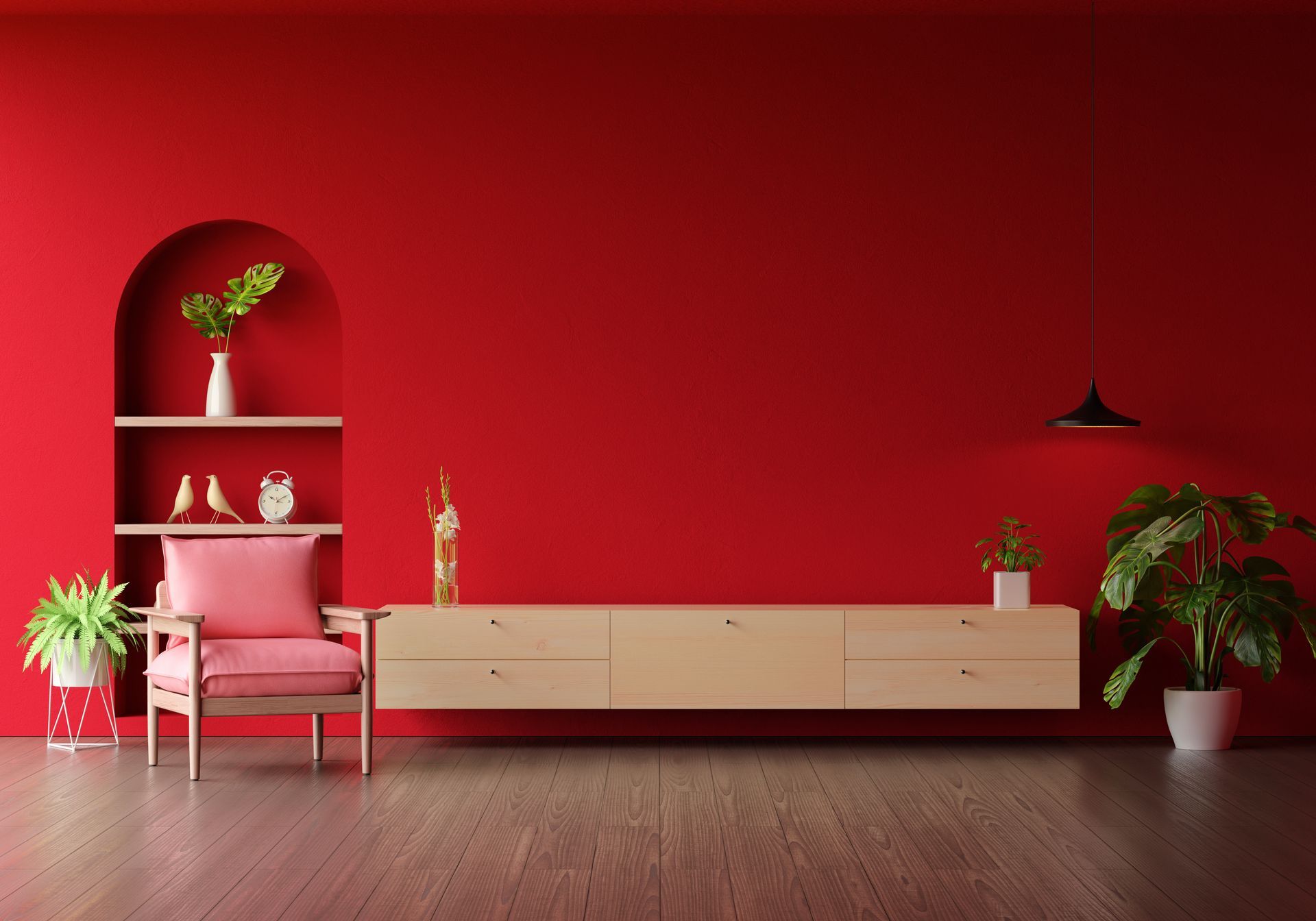 Red-walled living room with a built-in shelf, light wood console, pink armchair, and plants.