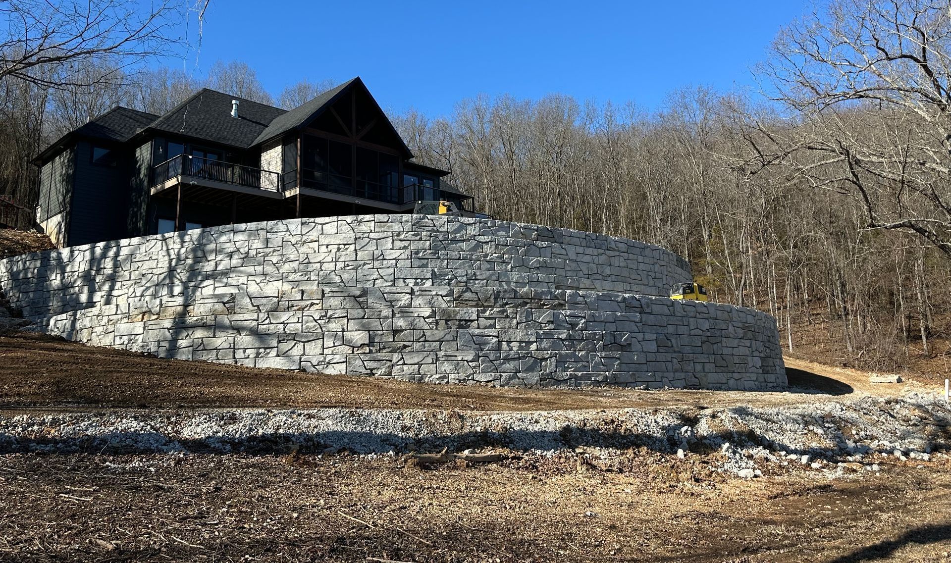 A construction worker is laying concrete blocks on a construction site.