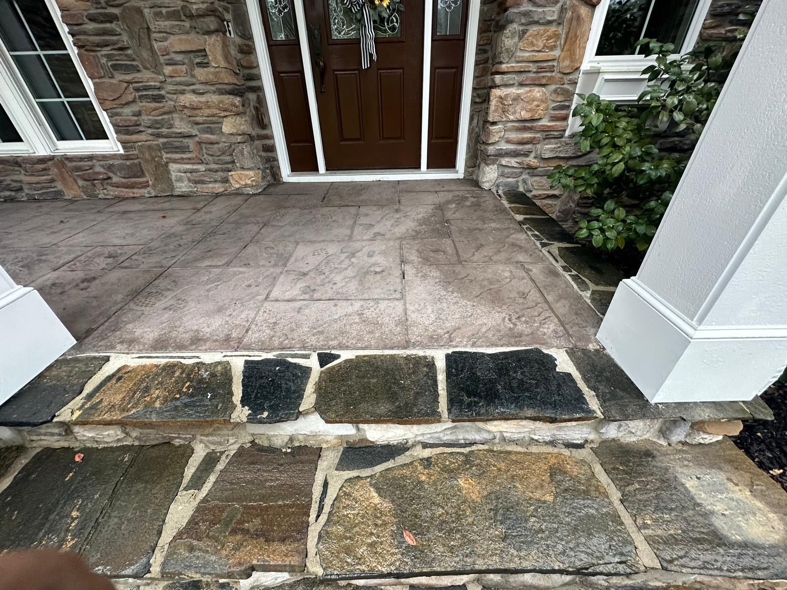 A stone walkway leading to the front door of a house.