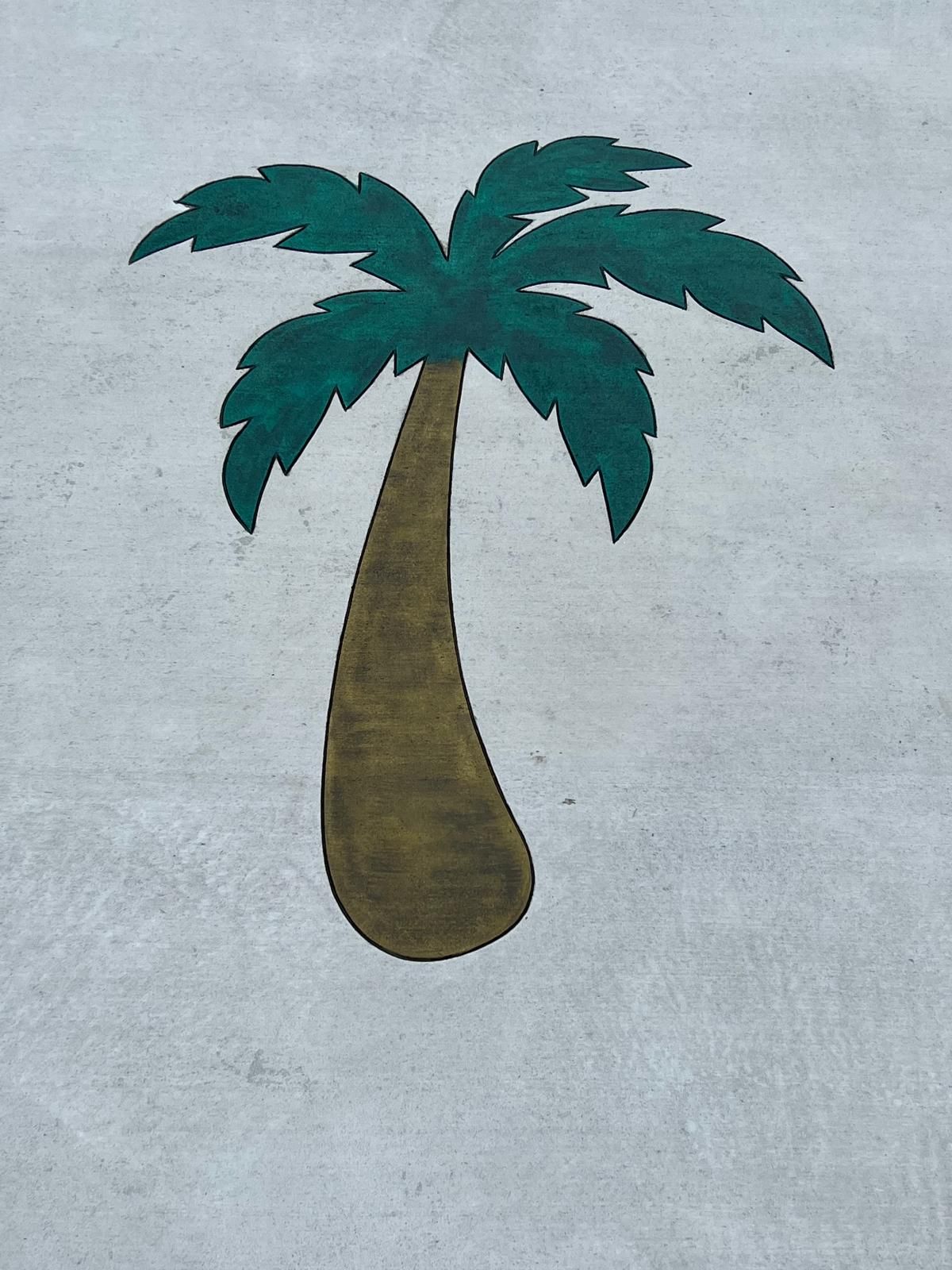 A palm tree is painted on a concrete surface