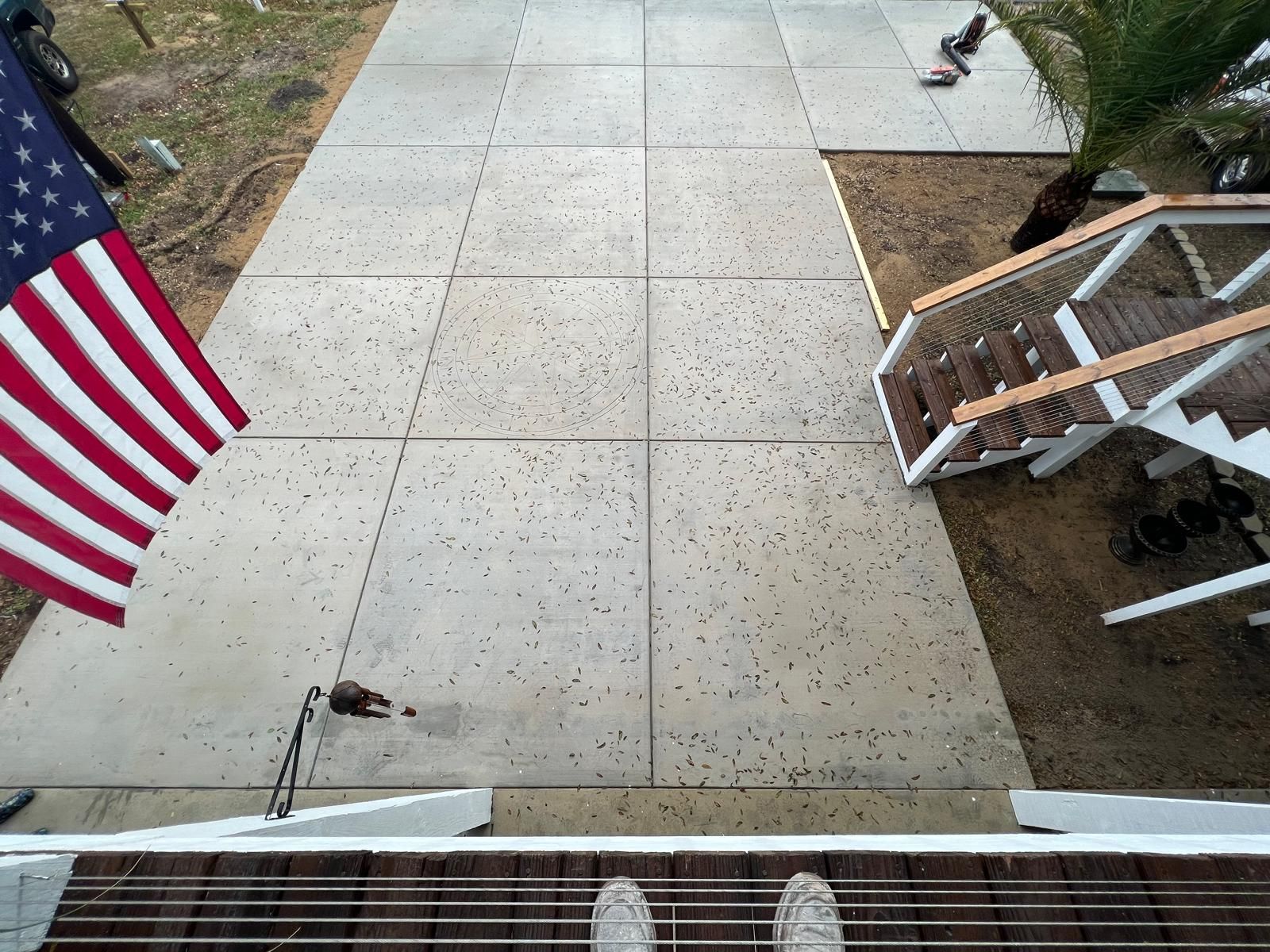 A person standing on a deck with an american flag in the background
