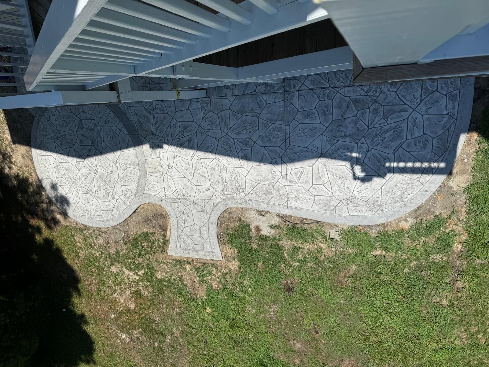 An aerial view of a walkway leading to a house