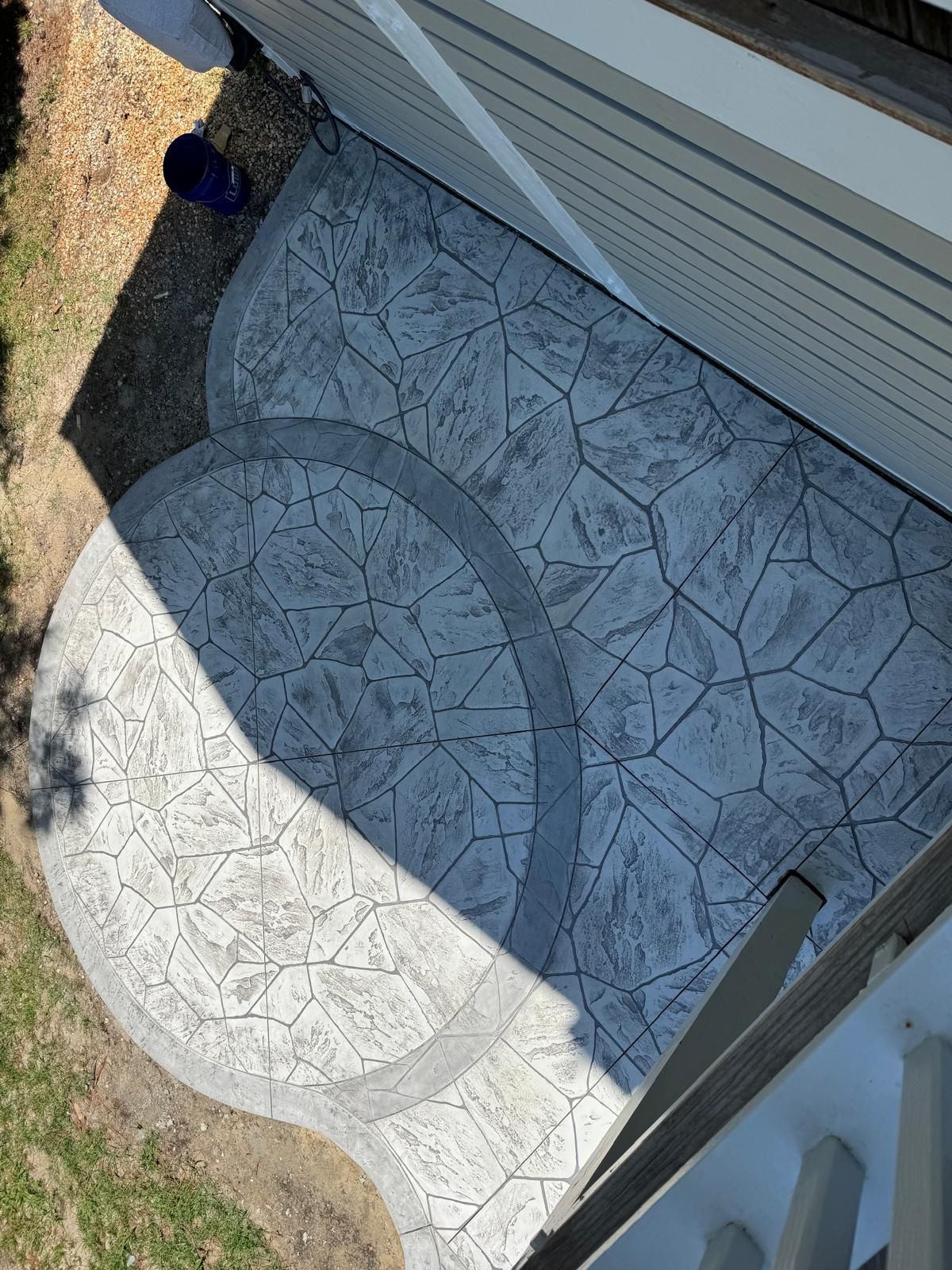 An aerial view of a concrete walkway leading to a house.