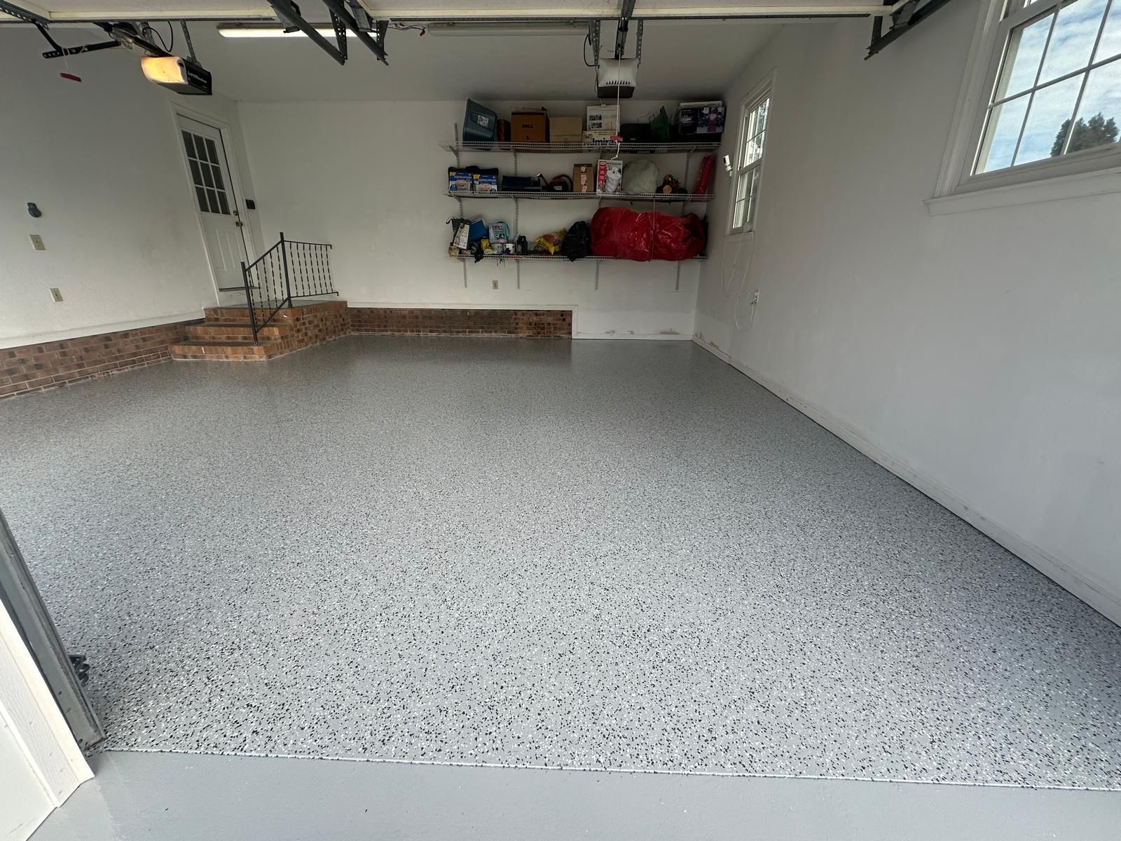 A garage with a gray floor and white walls.