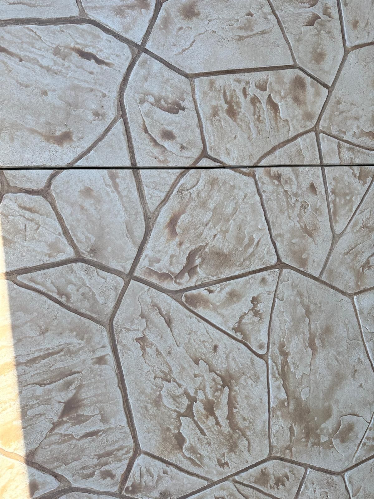 A close up of a concrete floor with a geometric pattern.