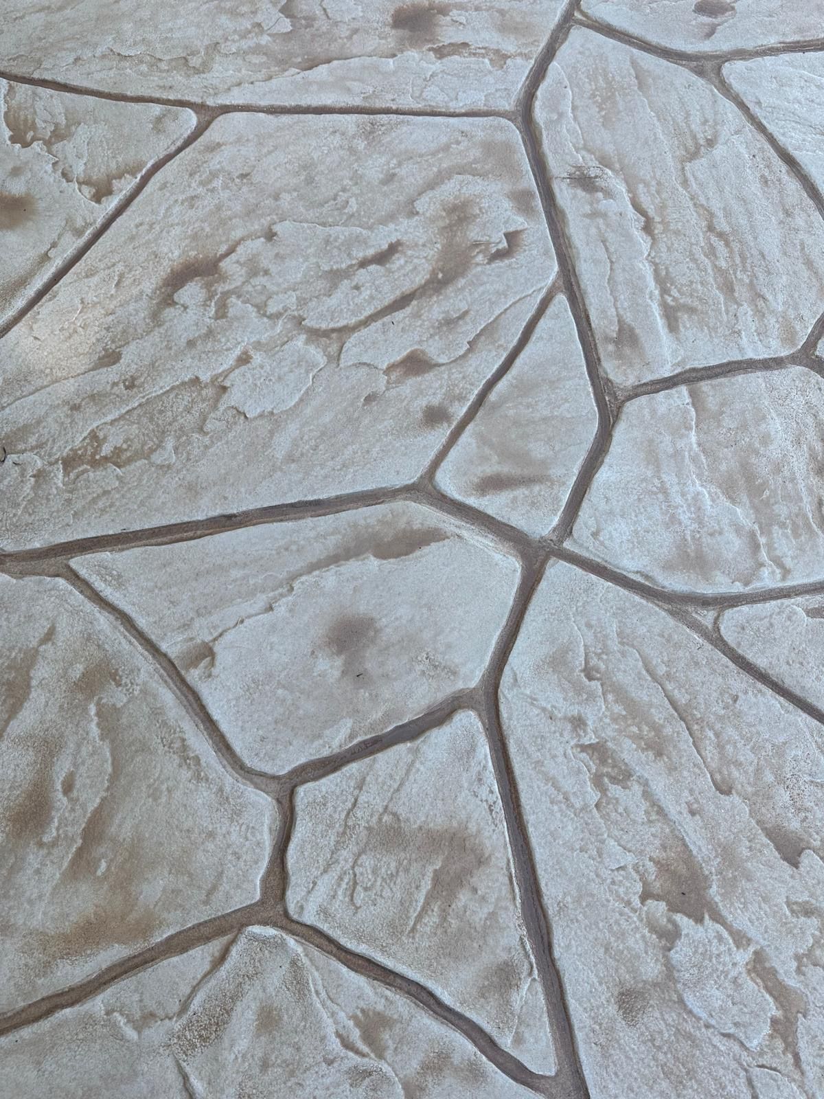 A close up of a stone floor with a geometric pattern.