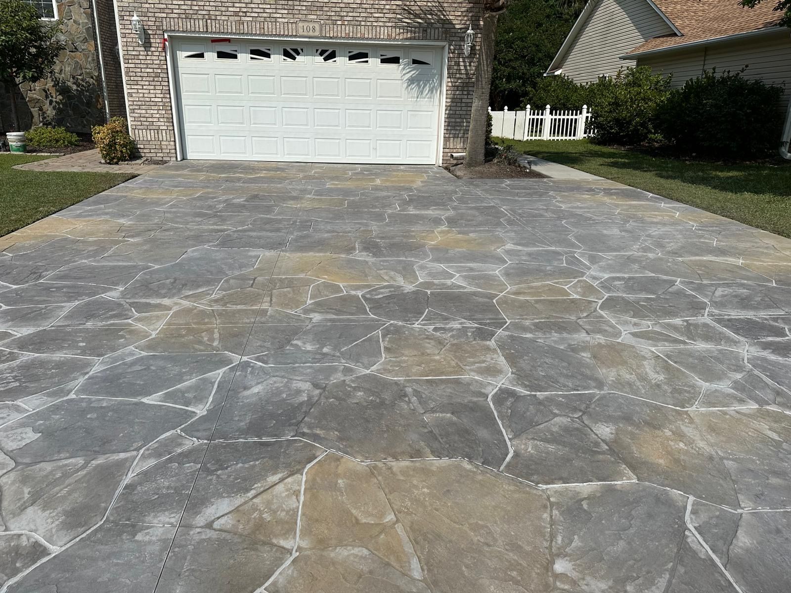 A driveway leading to a garage with a white garage door.